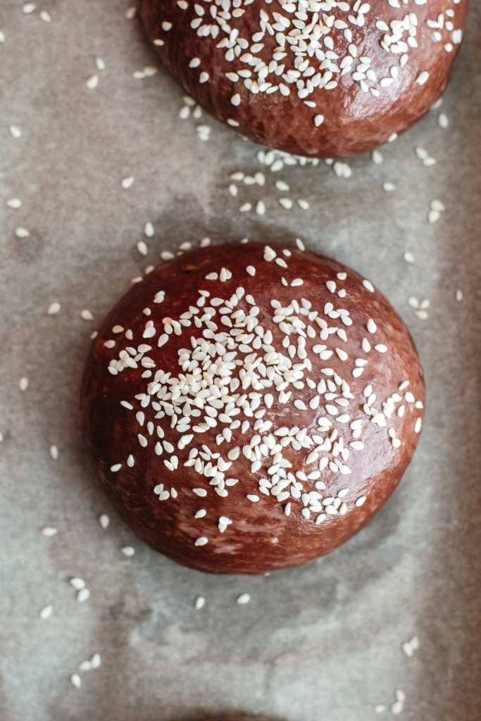 Uncooked cocoa buns with sesame seeds on top